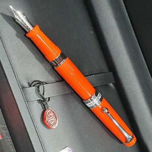 Orange fountain pen with silver clip and nib in a black gift box