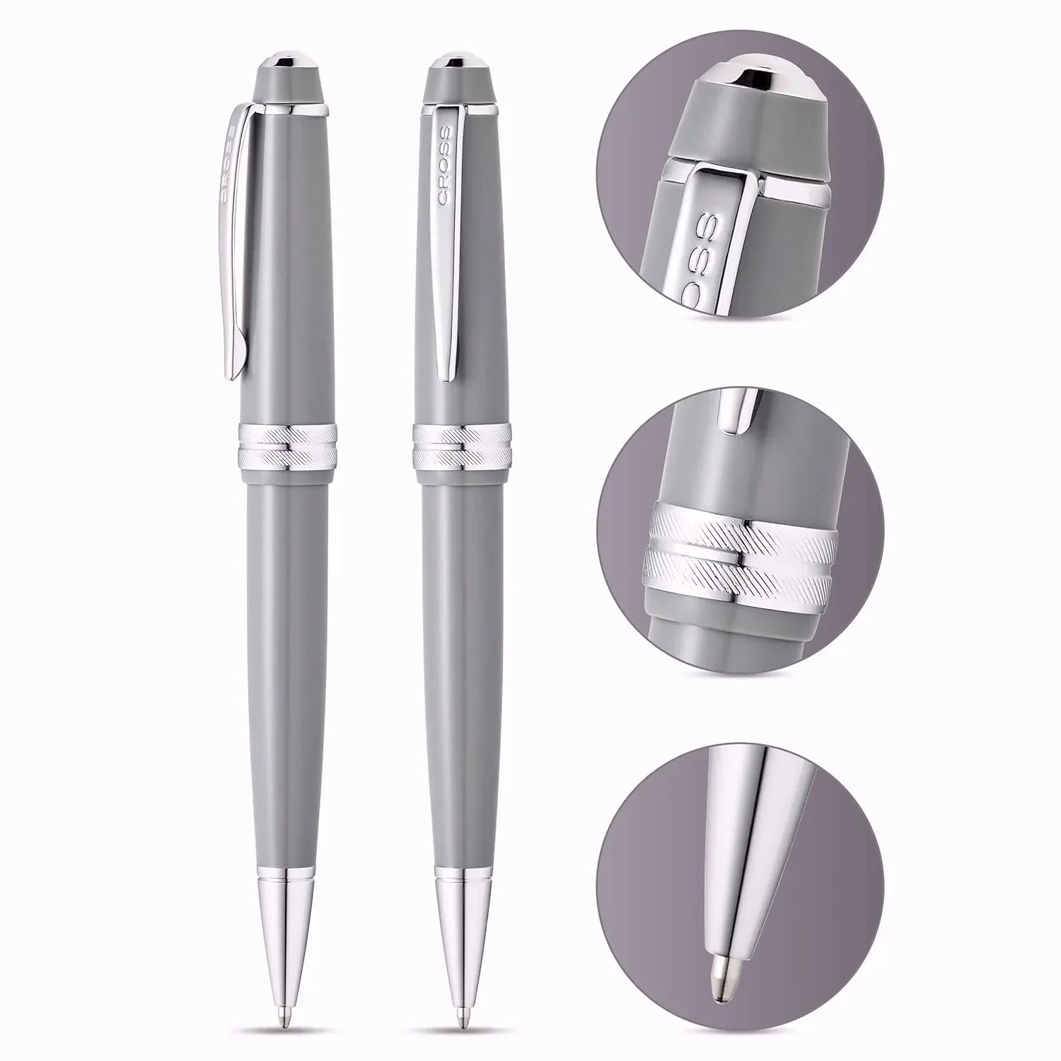 Light grey ballpoint pens with chrome accents, close-up details on clip, grip, and pen tip.