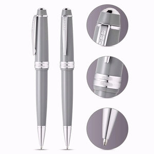 Light grey ballpoint pens with chrome accents, close-up details on clip, grip, and pen tip.