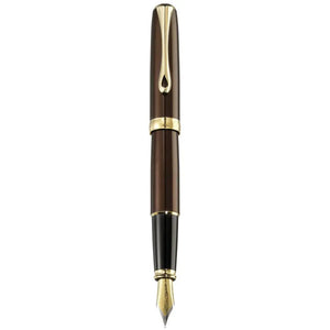 Luxury brown and gold fountain pen with gold nib on white background